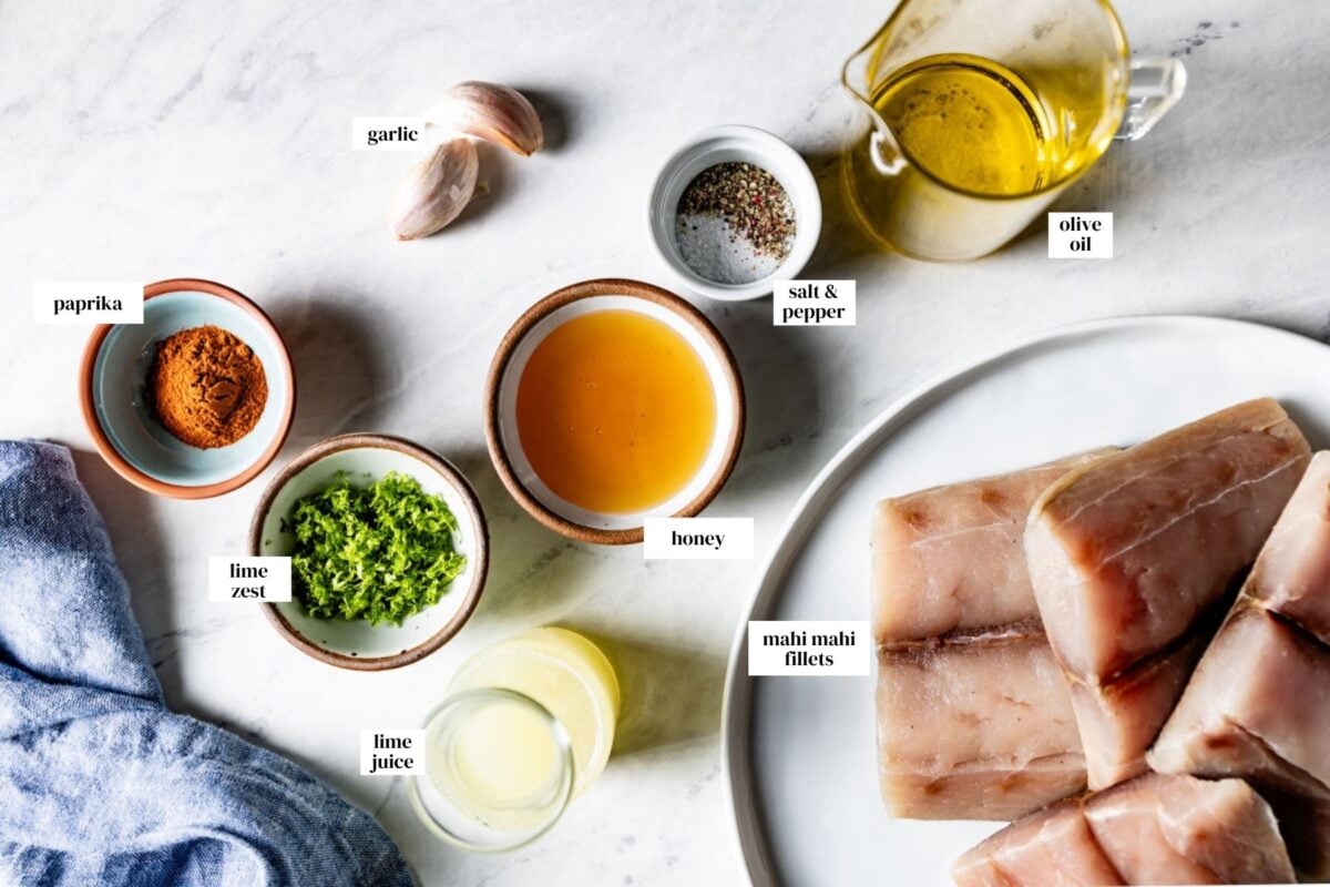 Ingredients for grilled mahi mahi marinade are measured in small cups with text on the image.
