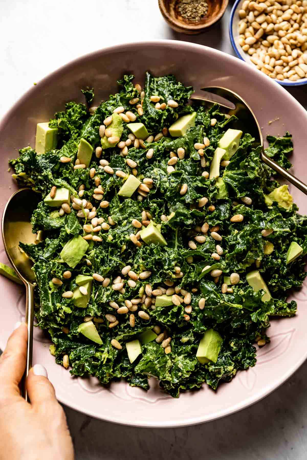 A fun summer salad made with kale and avocado served in a bowl