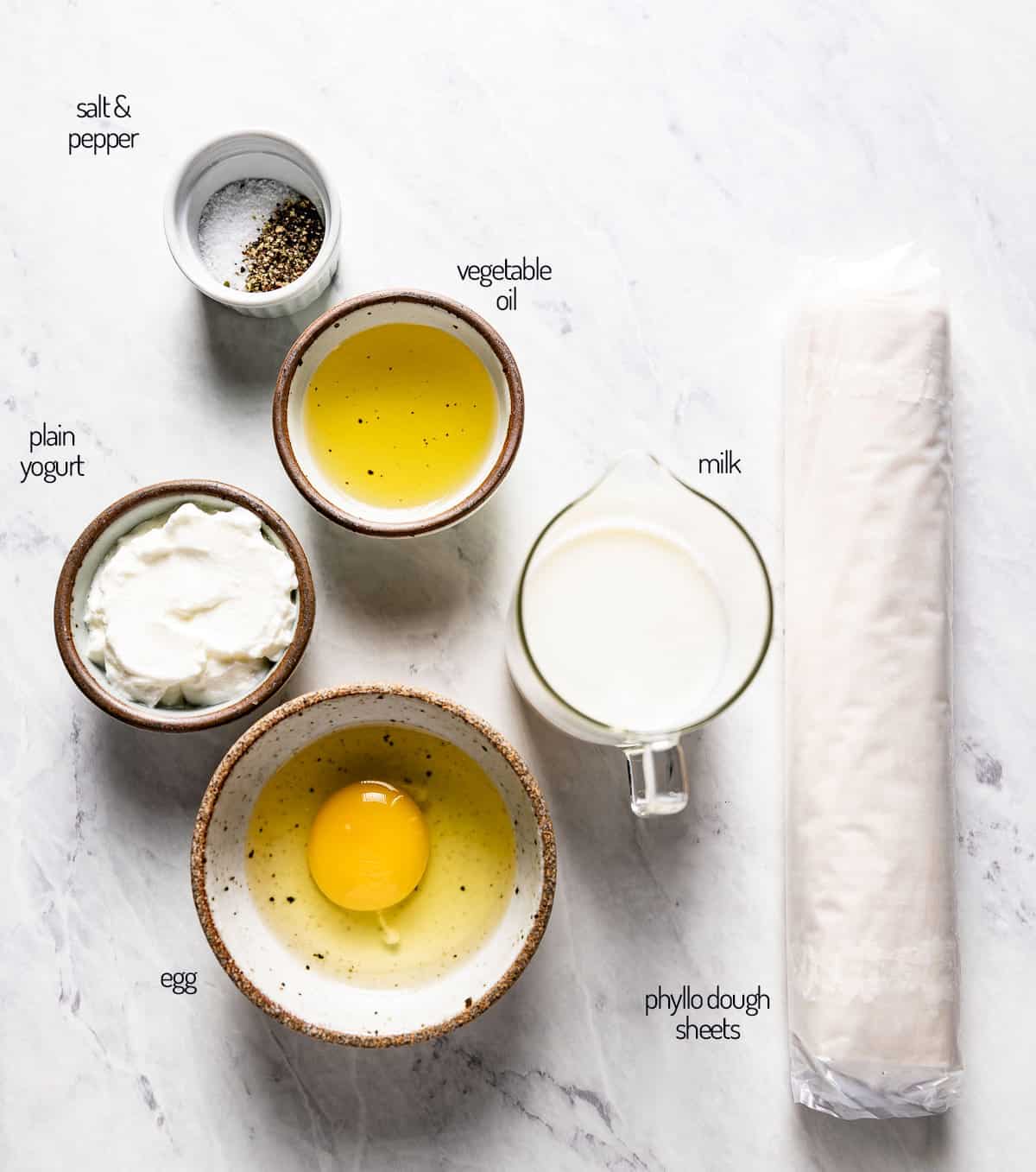 yogurt wash and phyllo dough - ingredients for borek recipe on a marble backdrop