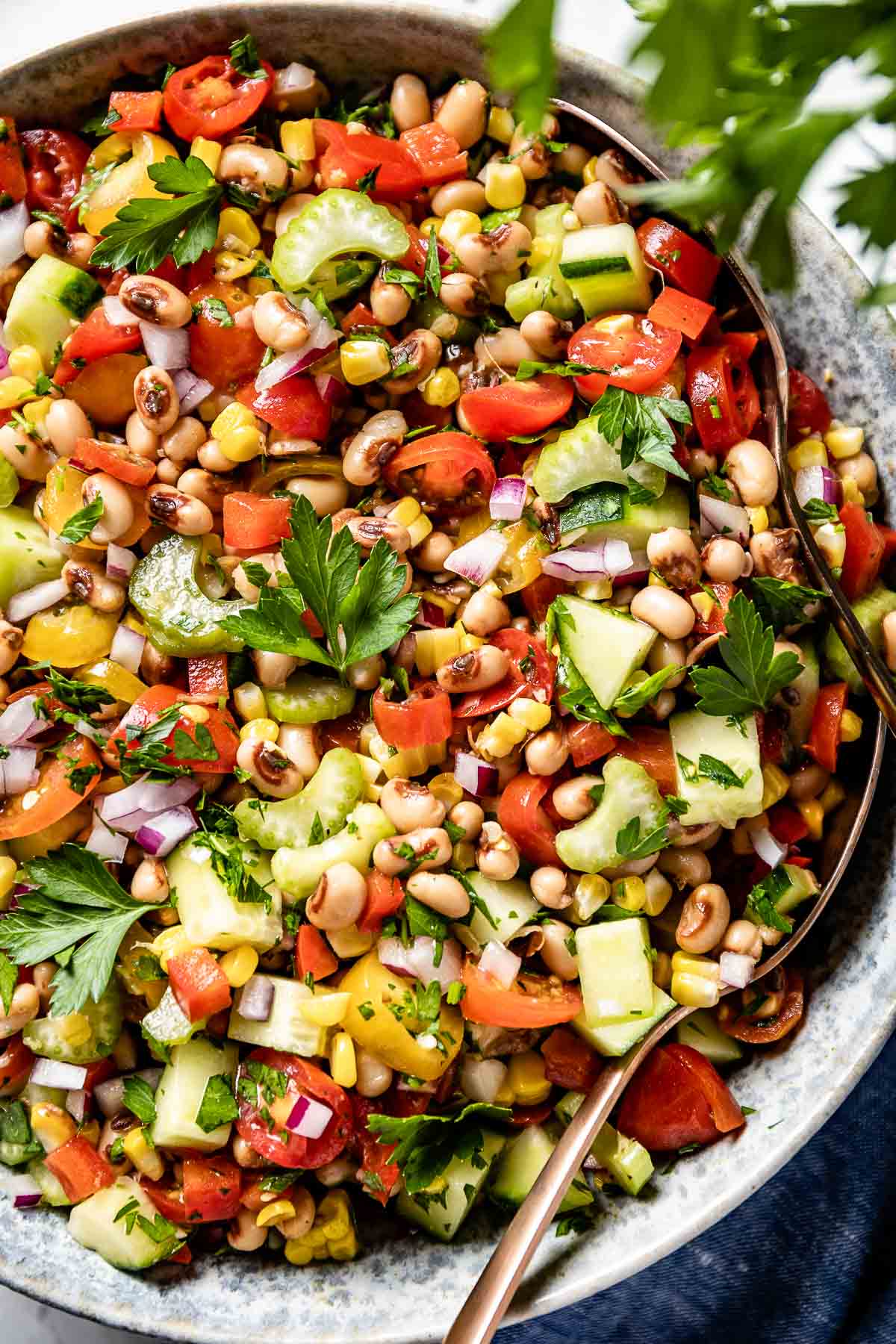 Blackeyed peas salad in a bowl with spoon on the side