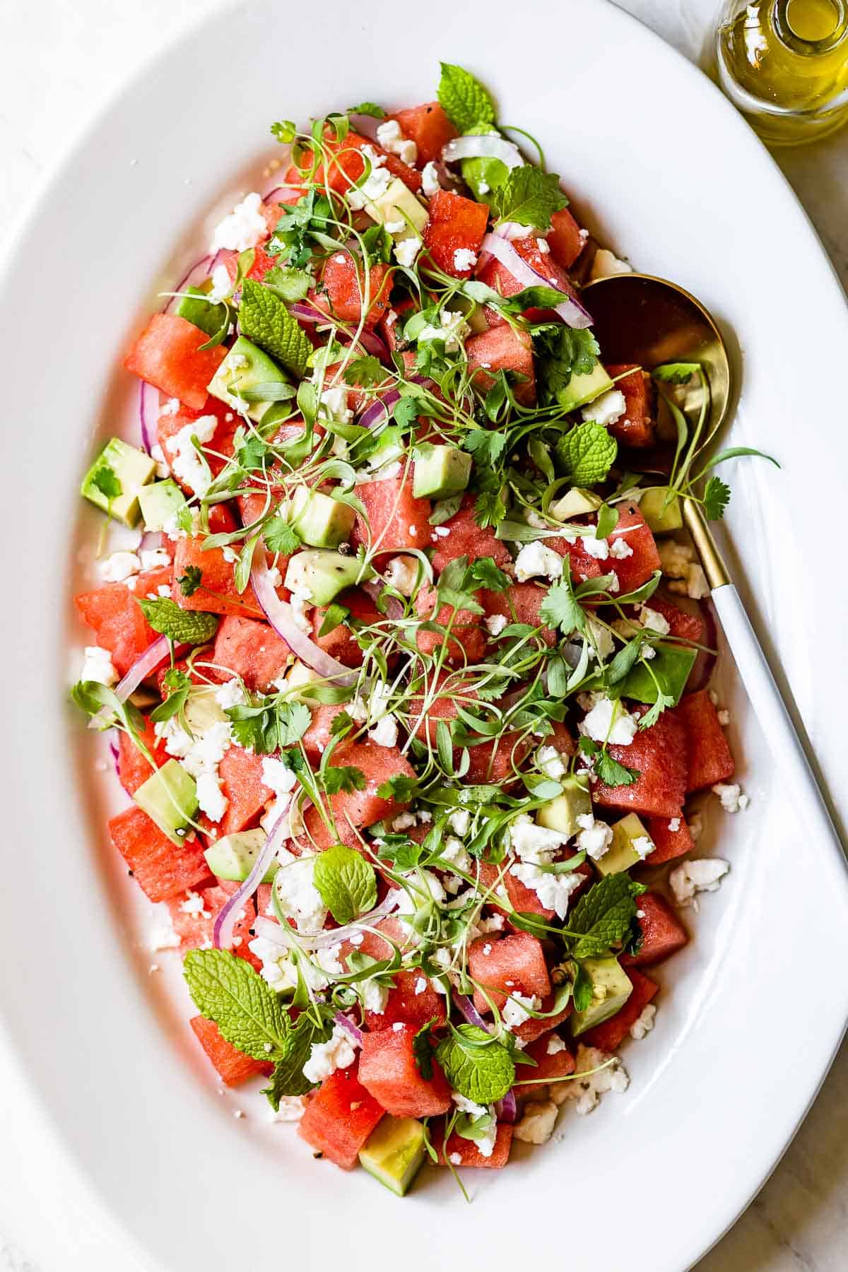 Watermelon Avocado Salad recipe topped off with microgreens
