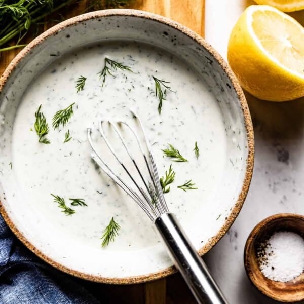 Yogurt Dill Sauce in a bowl with a whisk in the bowl