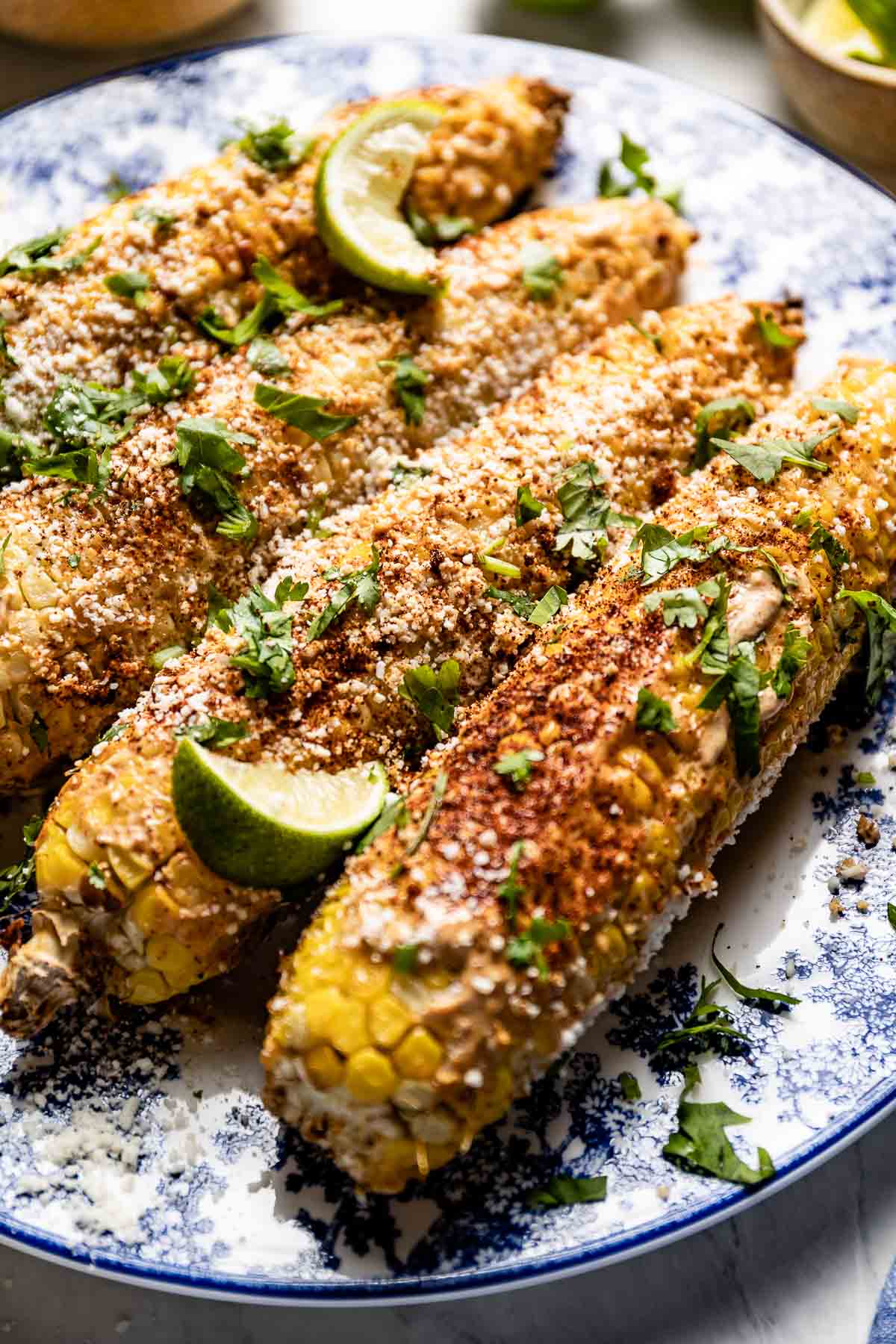 air fryer street corn with toppings from the side view