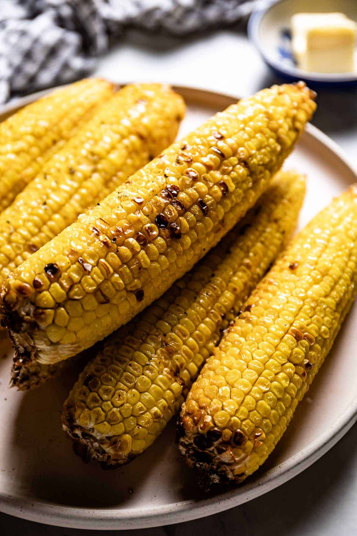A plate of corn on the cob in air fryer recipe from side view