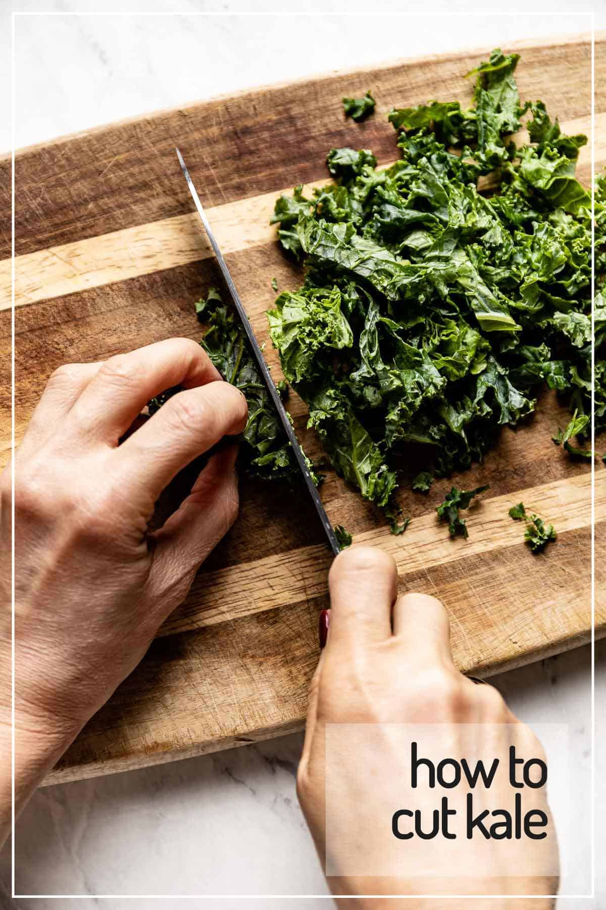 A person chopping kale on a cutting board from the top view. 
