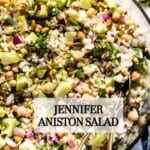 The Jennifer Aniston Salad with bulgur in a bowl with spoons from the top view.