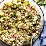 Jennifer Aniston Salad recipe in a bowl with spoons from the top view.