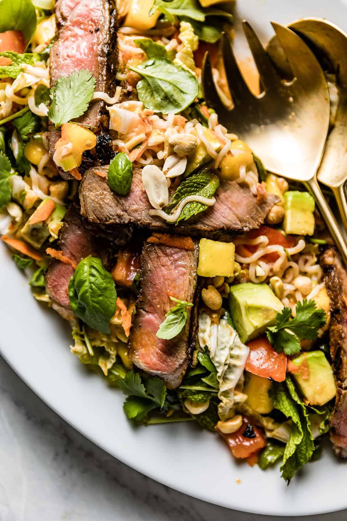 Thai beef salad with noodles on a plate from the top view