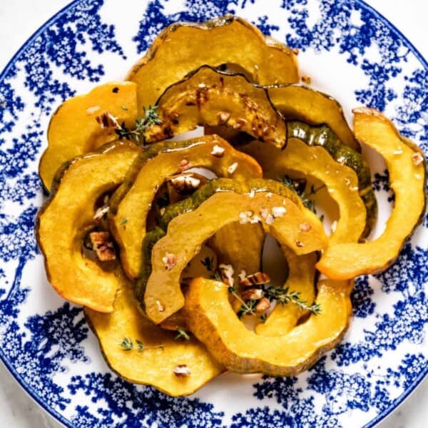 A plate with slices of roasted squash from the top view.