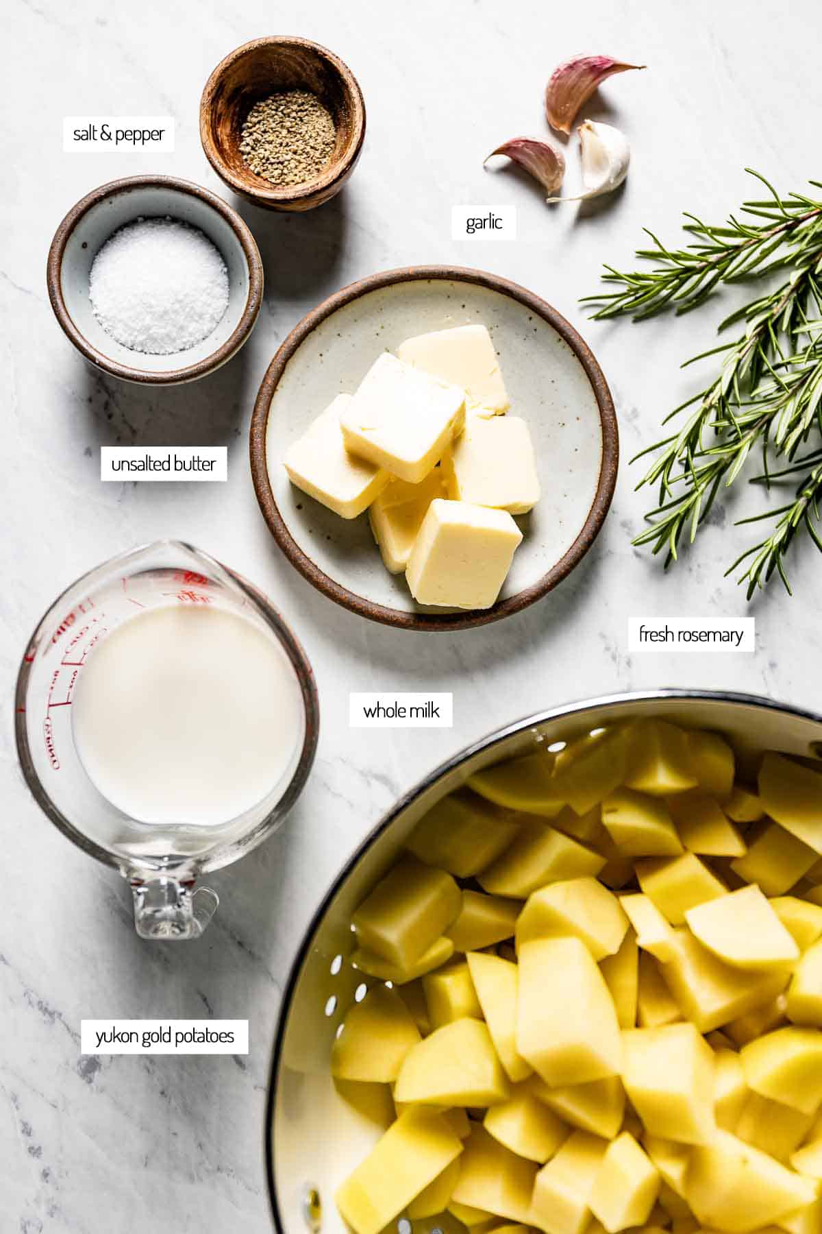 Ingredients for potatoes mashed with butter and rosemary from the top view.