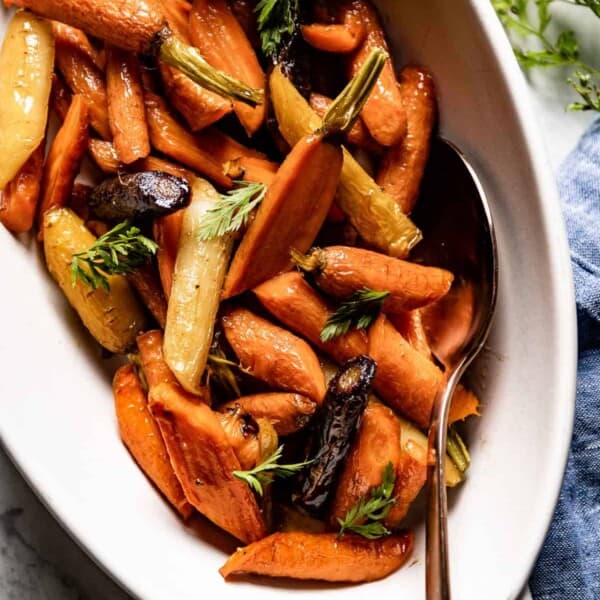 Maple roasted carrots in a serving bowl from the top view.
