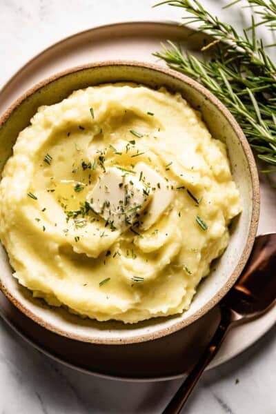 Rosemary mashed potatoes in a bowl from the top view.