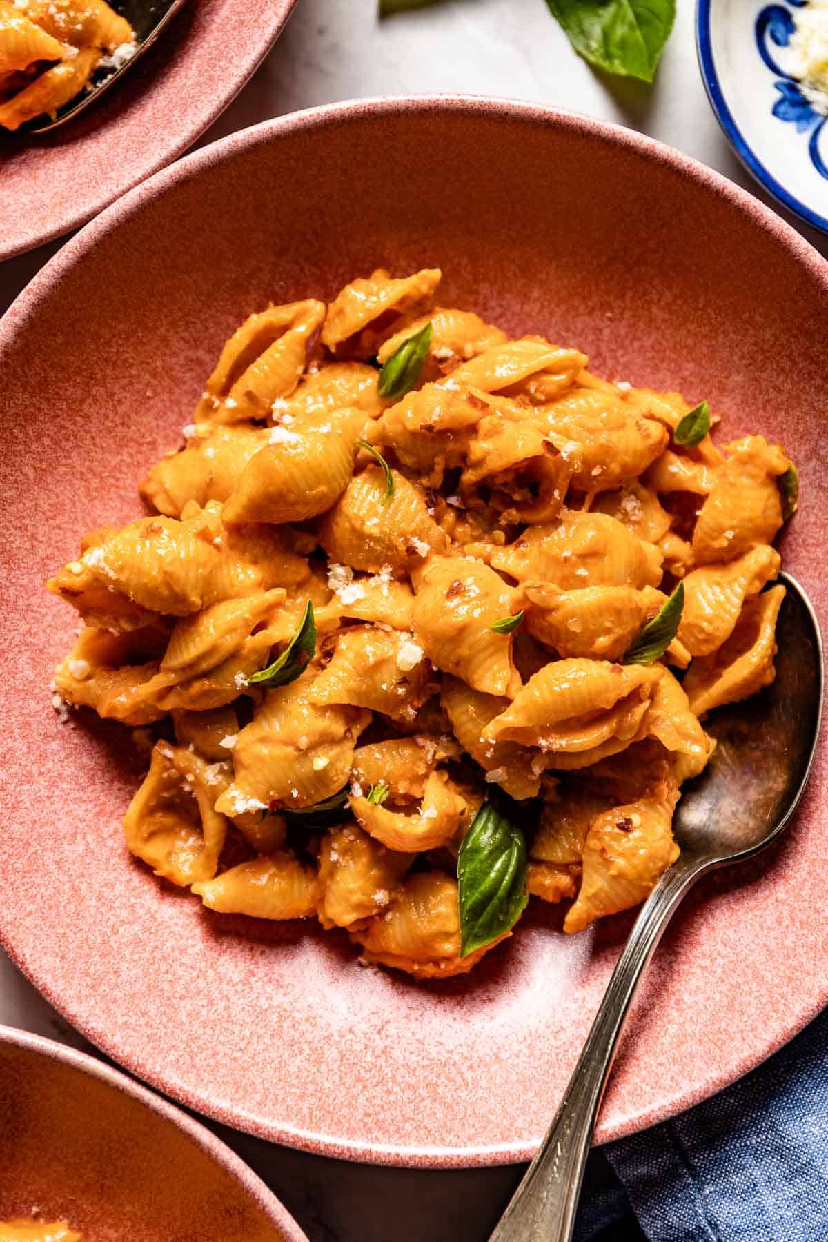 A serving of Gigi Hadid creamy pasta with basil in a bowl from the top view. 