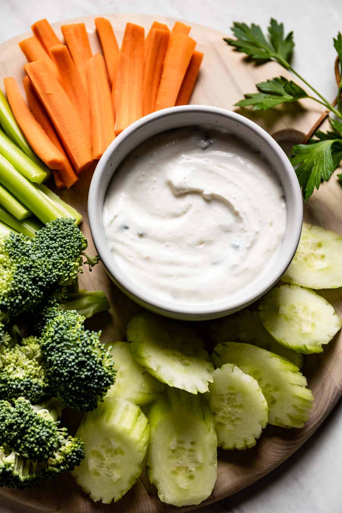 A dip with a greek yogurt base served with veggies from the top view.