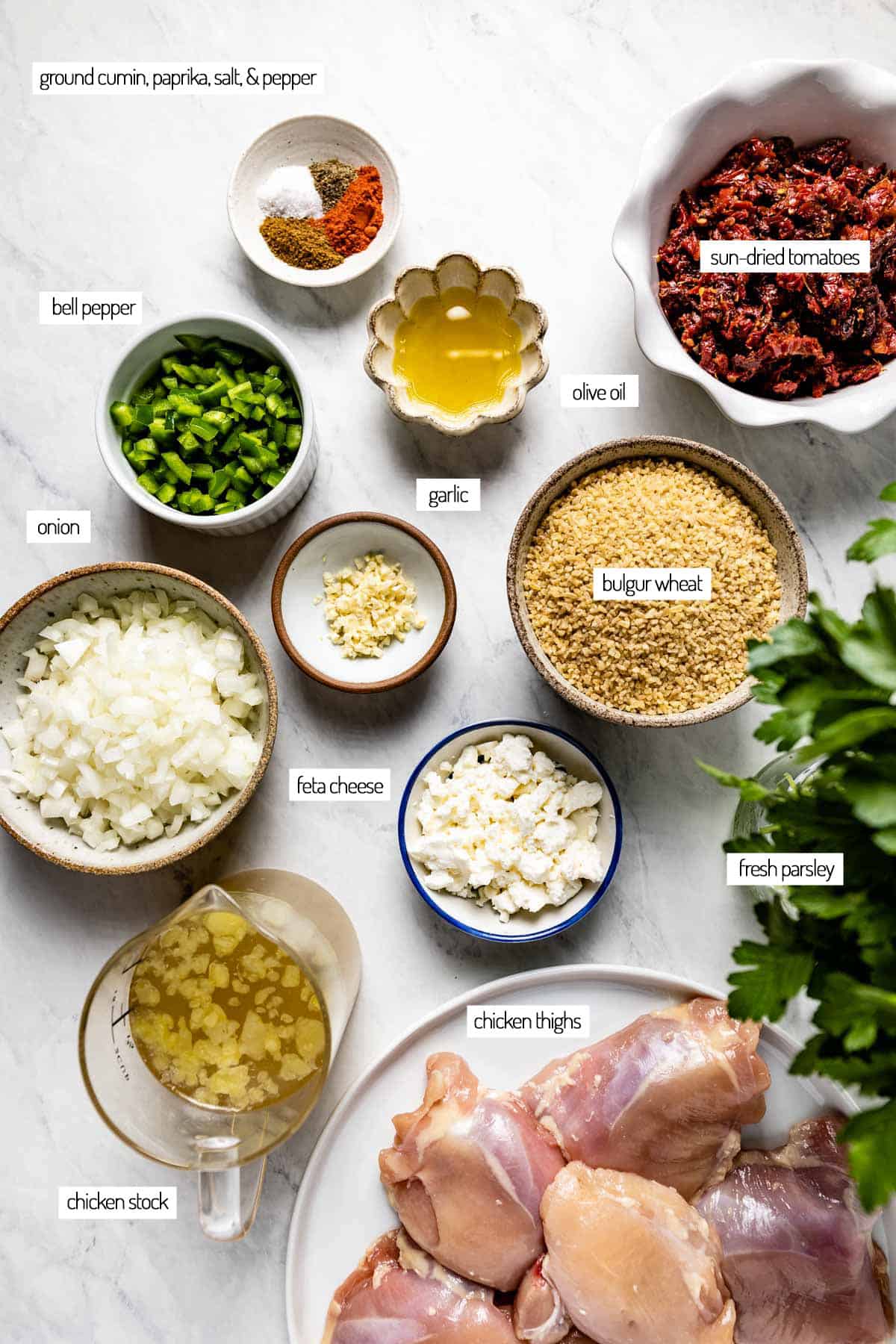 Ingredients for a dish with chicken thighs and bulgur from the top view. 