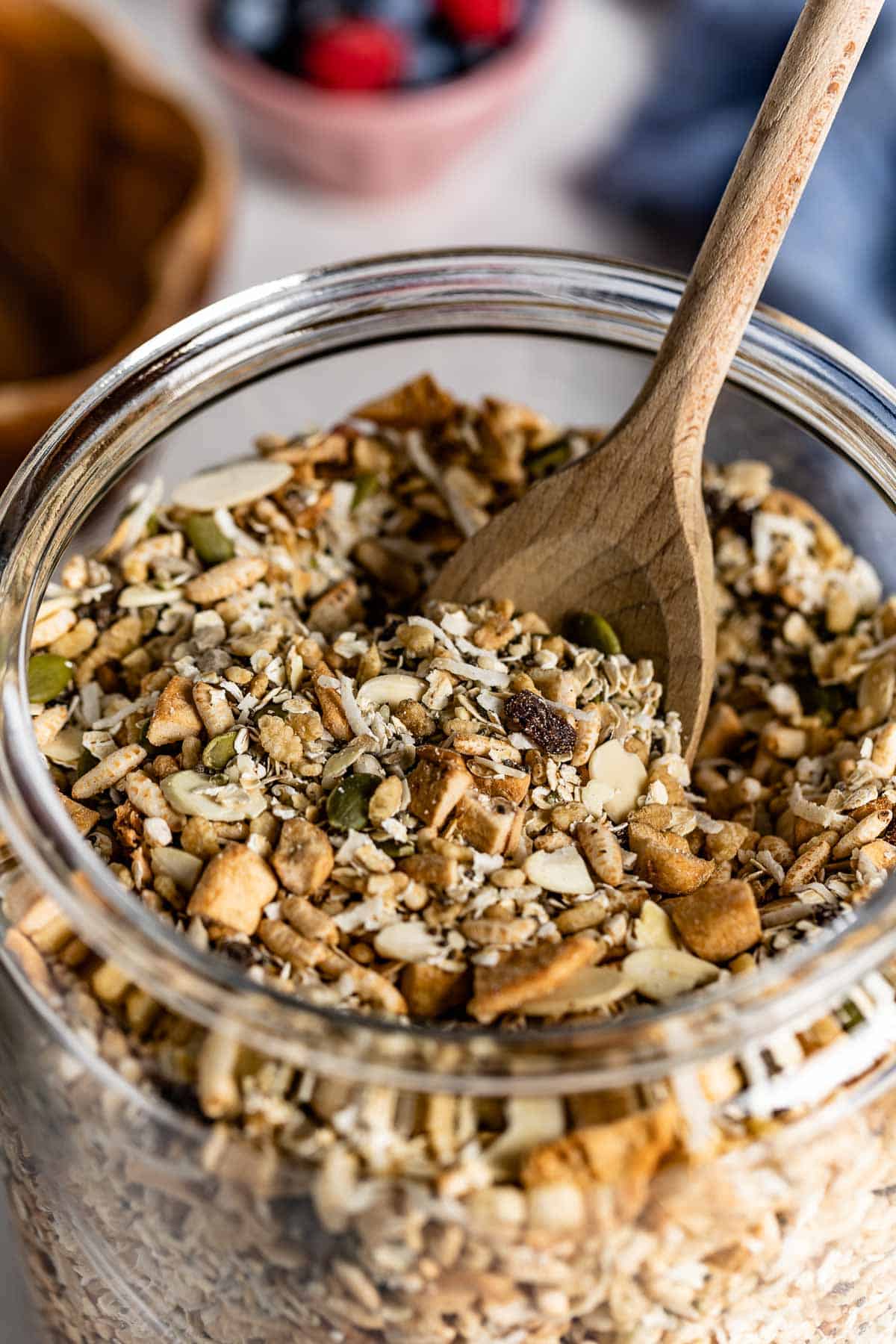 A homemade cereal in a jar with a spoon from the top view.