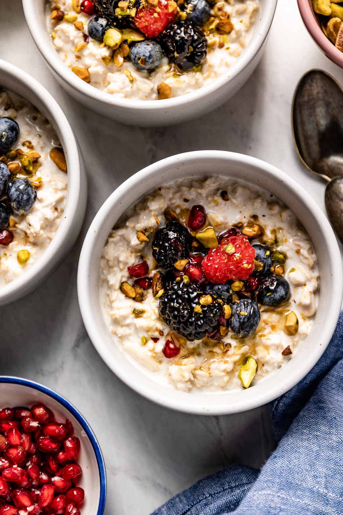 Oatmeal combined with yogurt in a bowl with fruit from the top view.