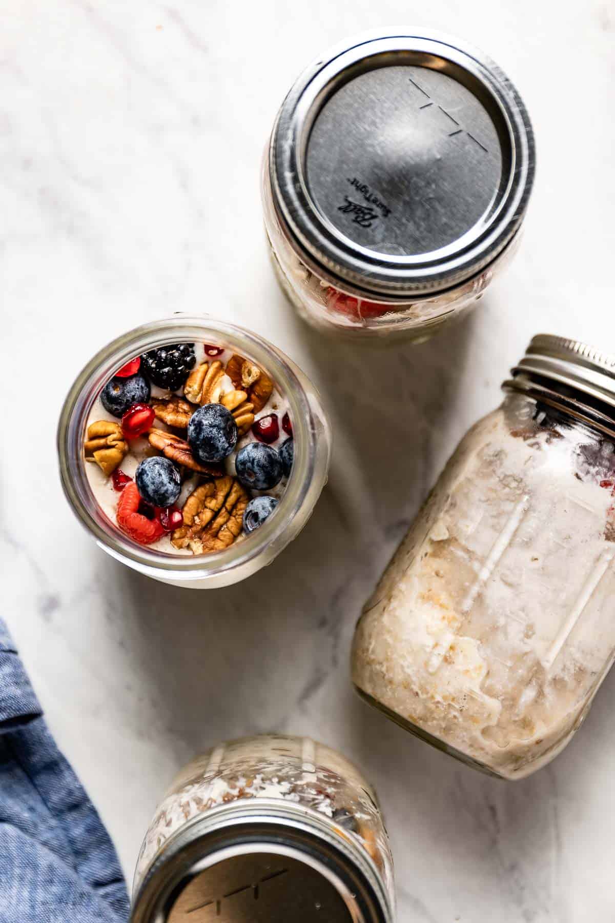 Slow cooker oatmeal with steel cut oats cooked in mason jars from the top view.
