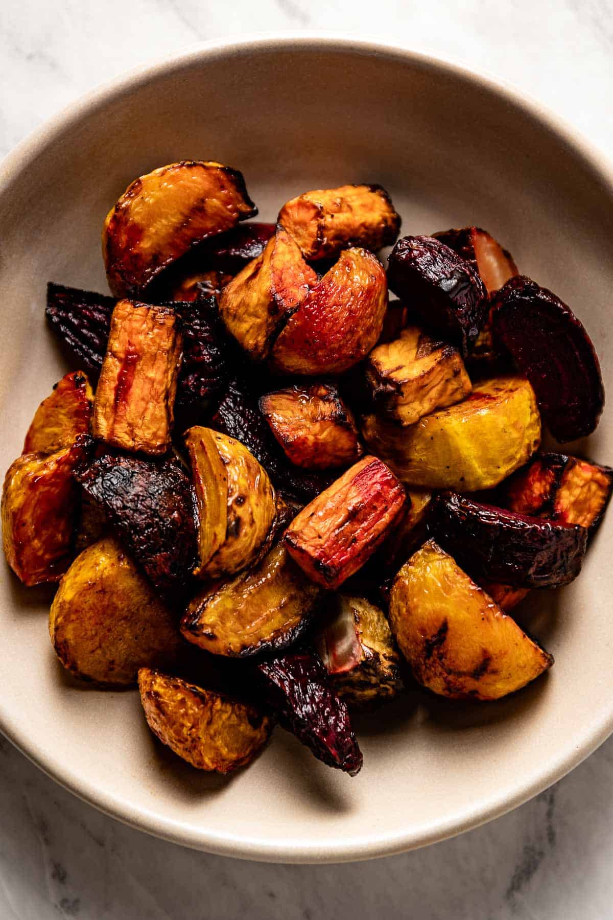 Air fryer beets and sweet potatoes in a bowl from the top view.