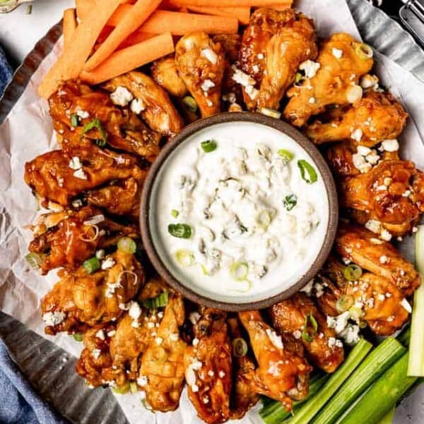 Slow cook wings with vegetables from top view.
