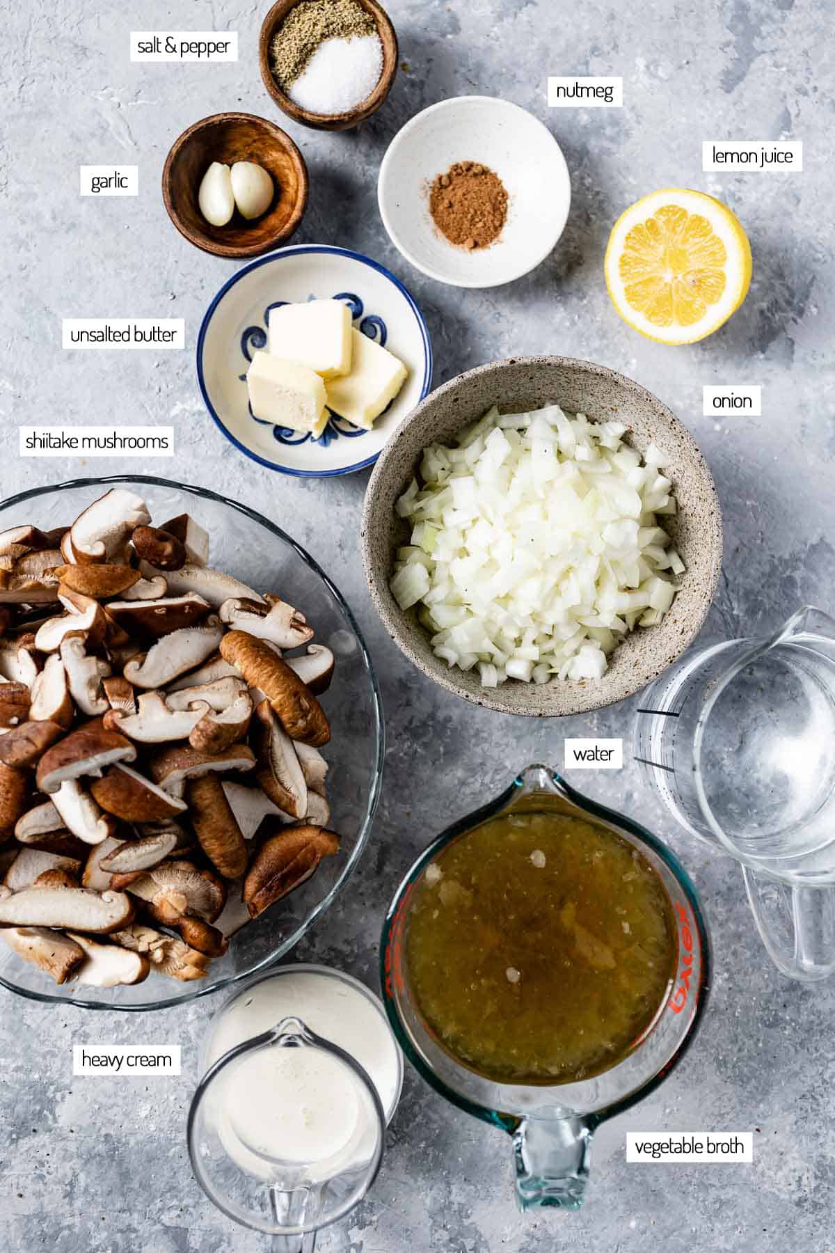 Ingredients for a fresh shiitake mushroom soup in bowls from the top view.