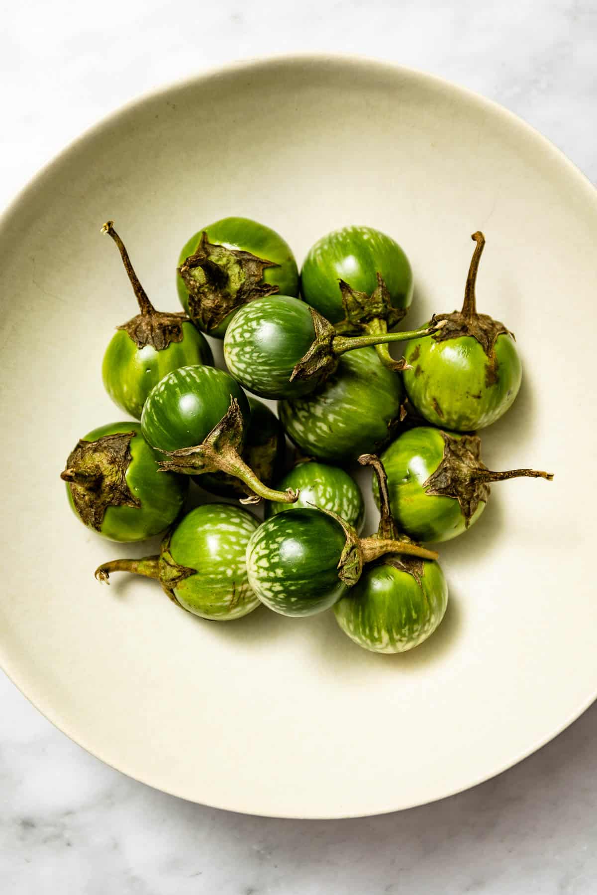 Thai eggplants in a bowl from the top.