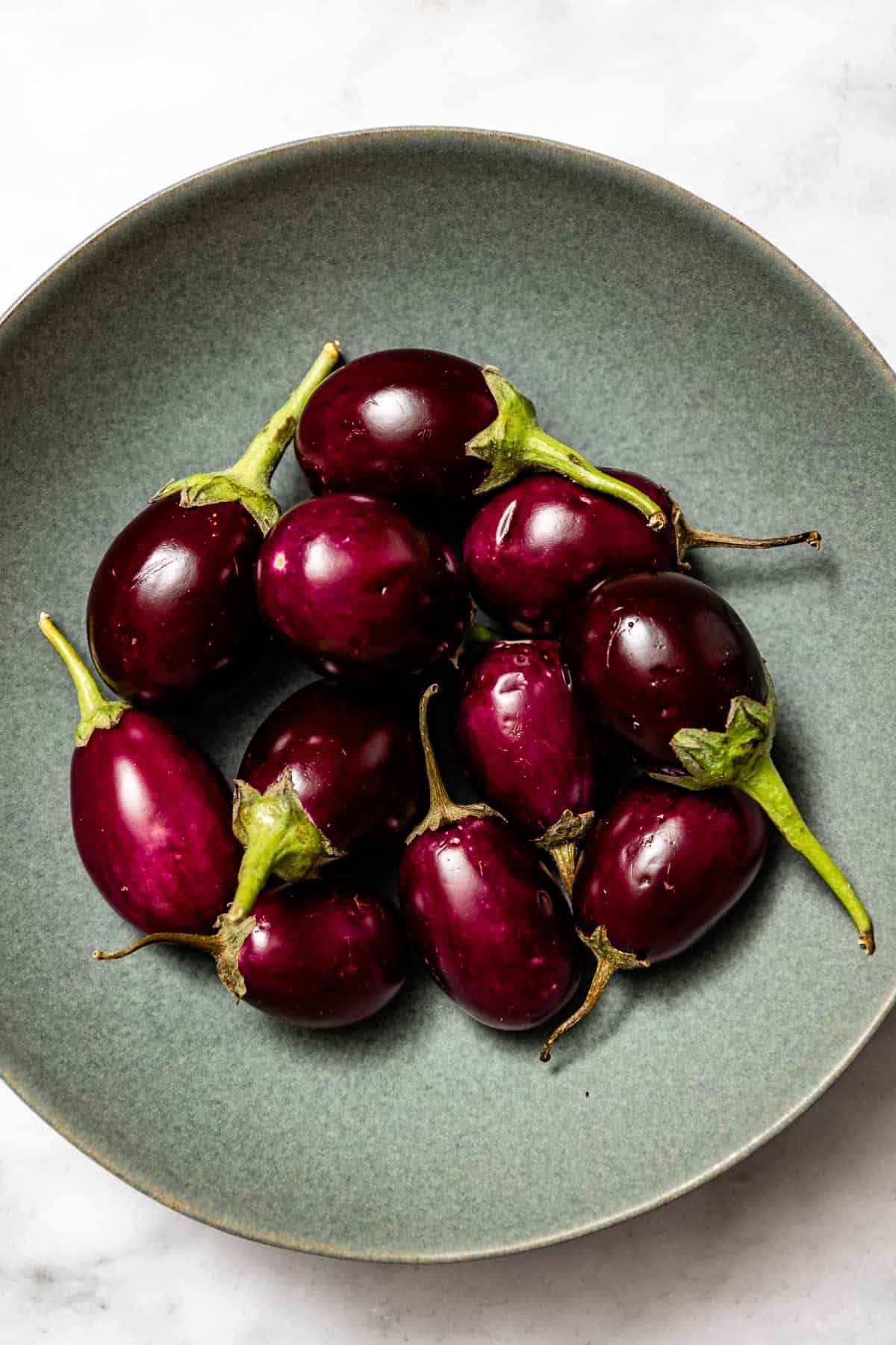 Indian eggplants in a bowl from the top view.