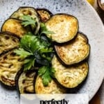 Pan fried eggplant on a plate with text on the image.