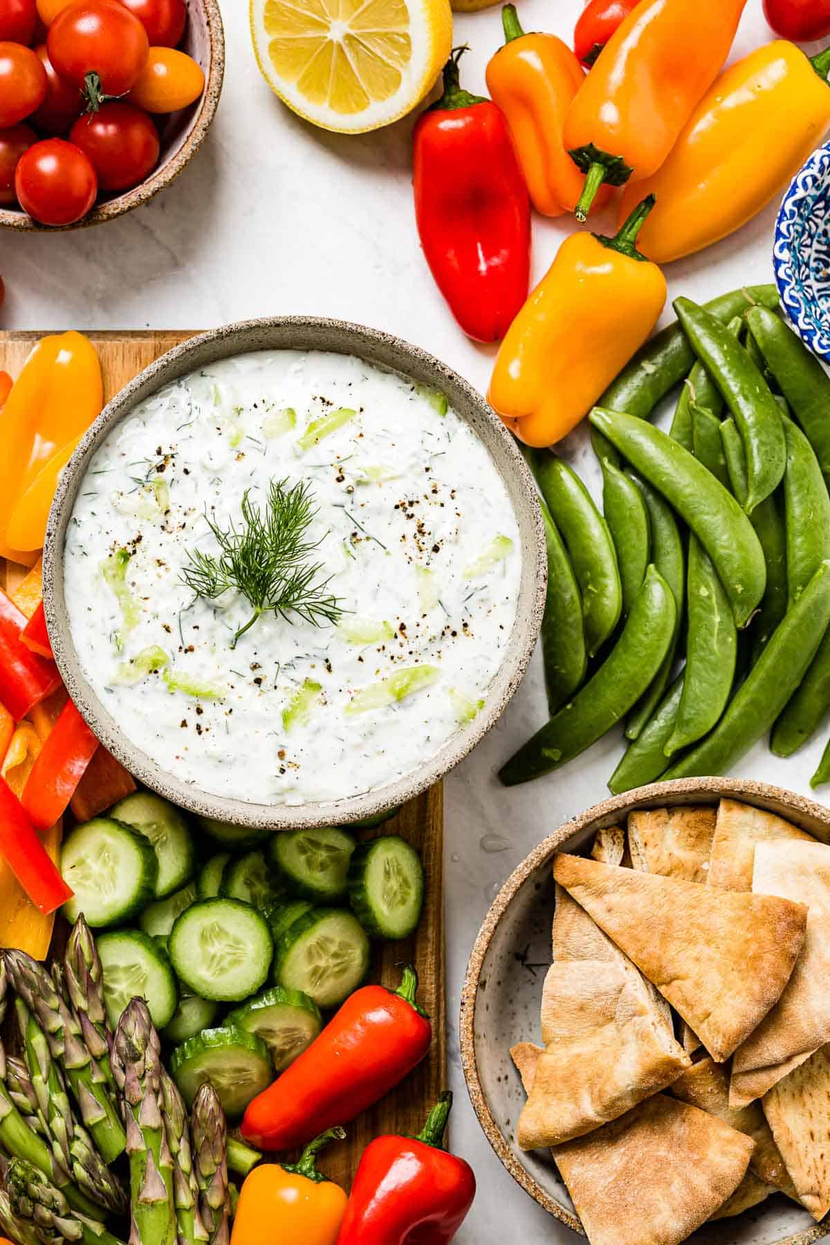 Authentic Tzatziki Sauce Recipe is served with colorful fresh vegetables.