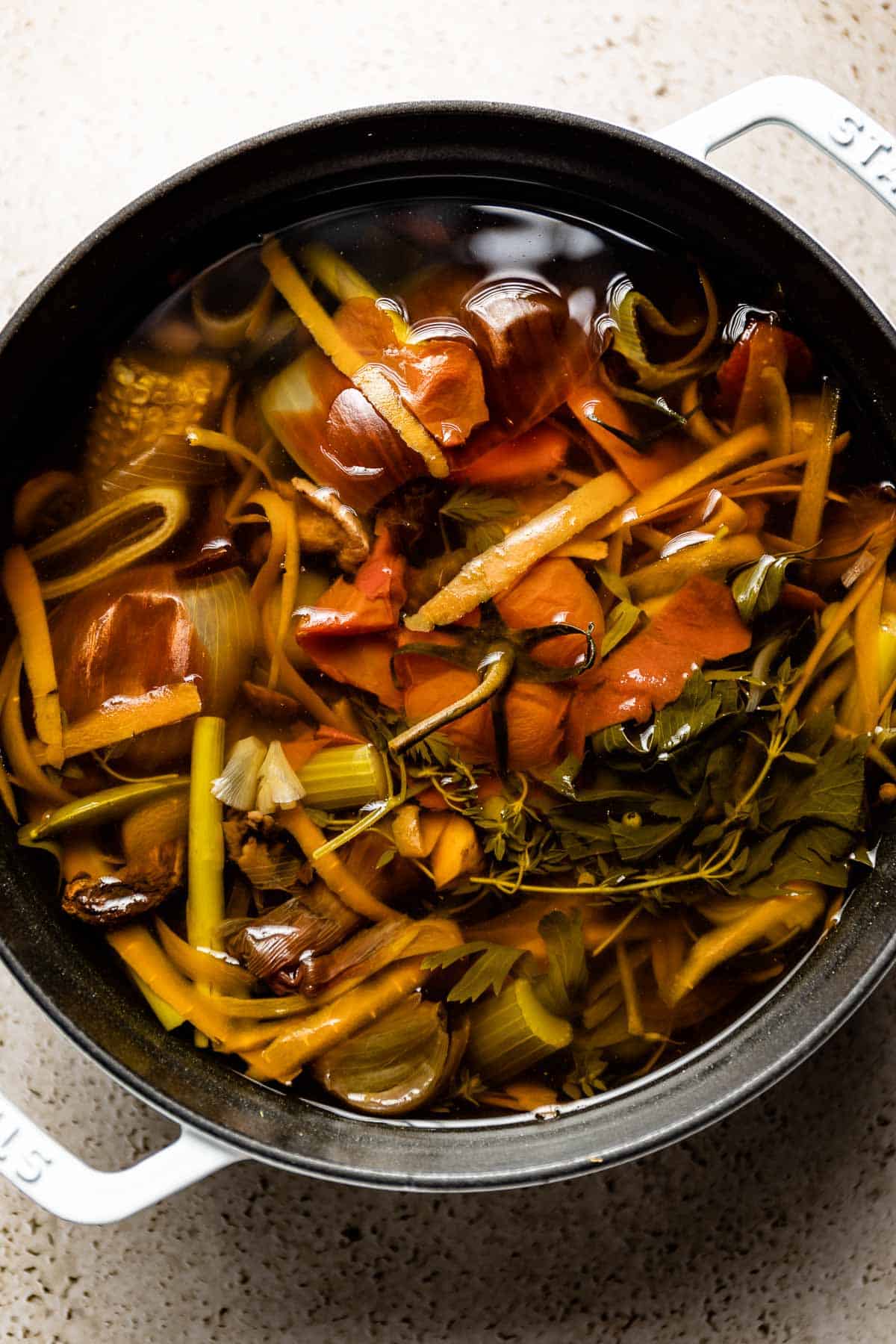 Vegetable scrap broth with veggies after the cooking time is completed.