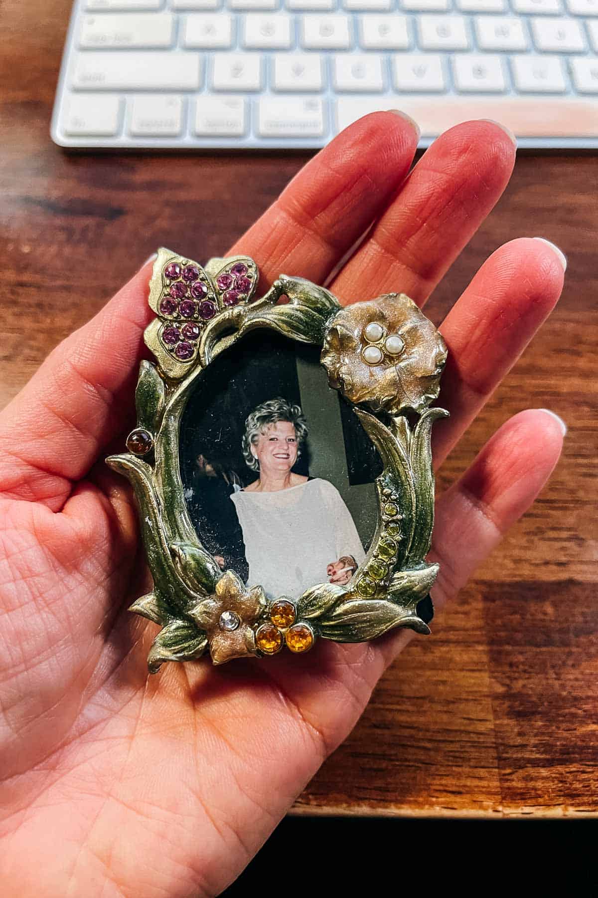 A photo frame in a woman's hand.