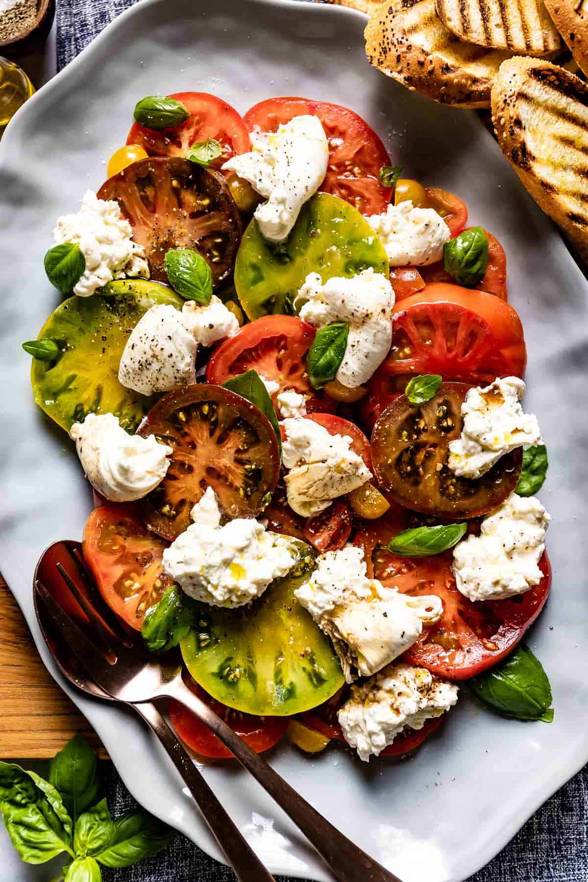 Burrata Caprese styled on a plate from the top view.