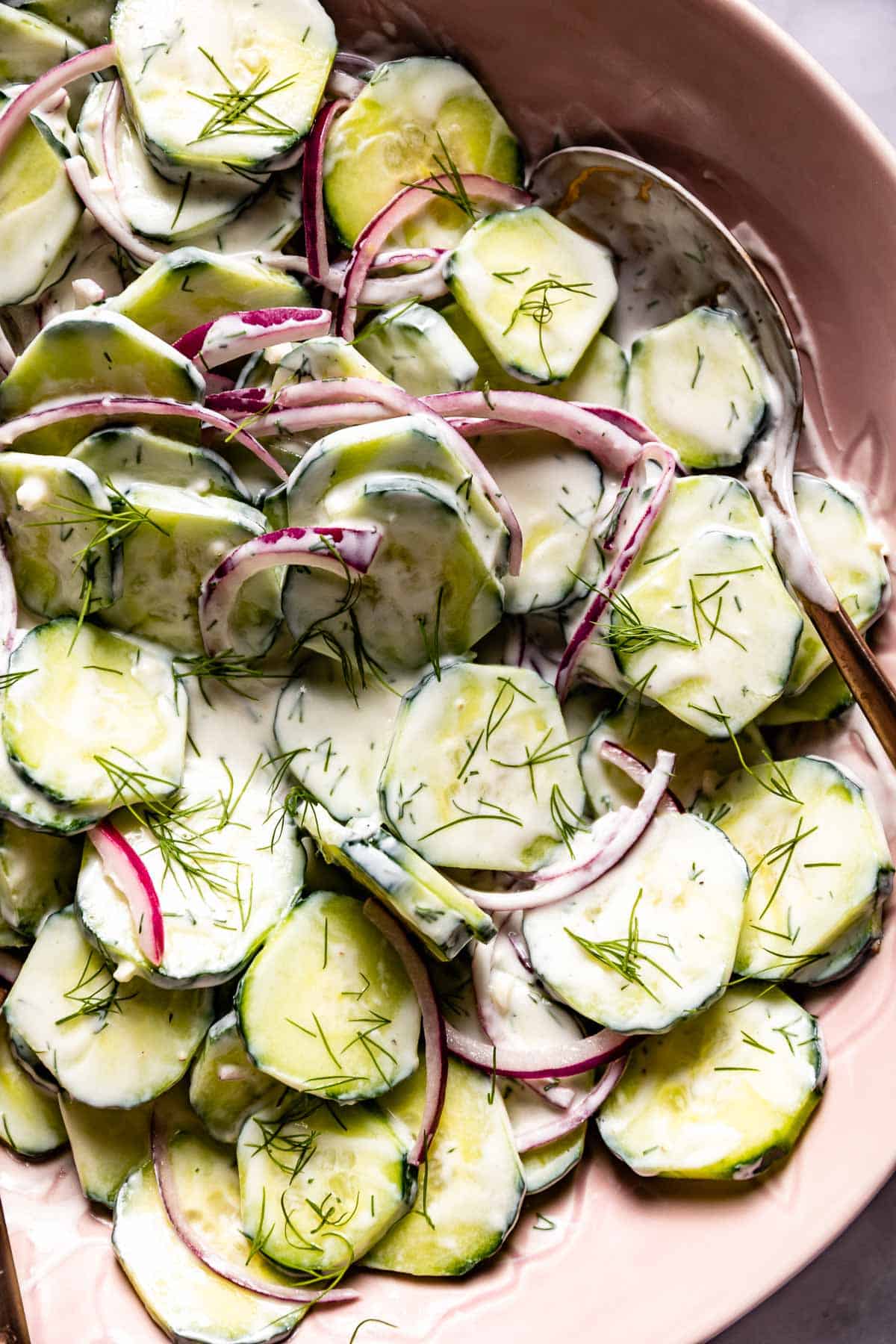 Greek cucumber salad recipe with greek yogurt dressing in a bowl from the top view.