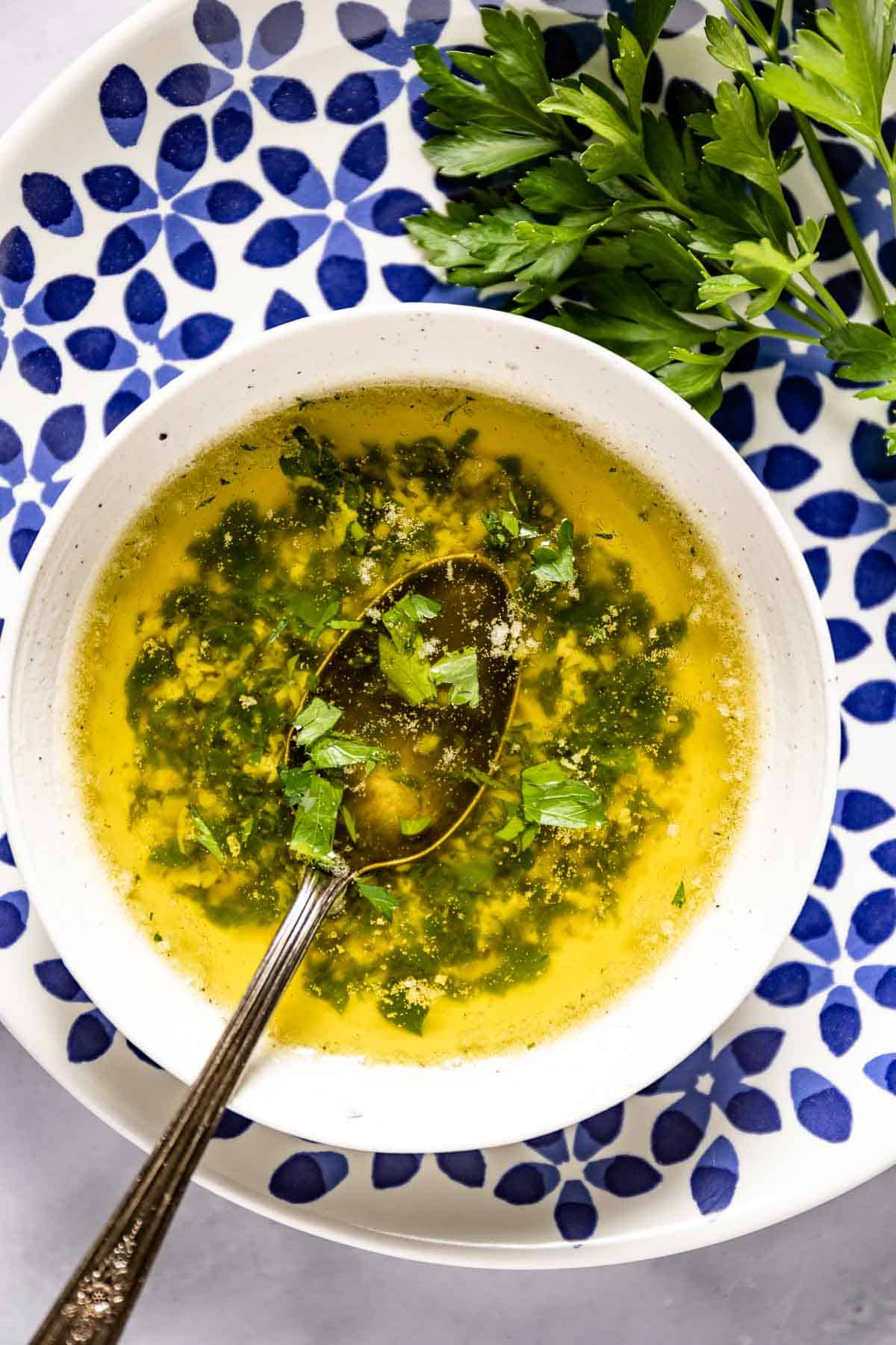 Seasoned garlic butter sauce in a small bowl from the top view.