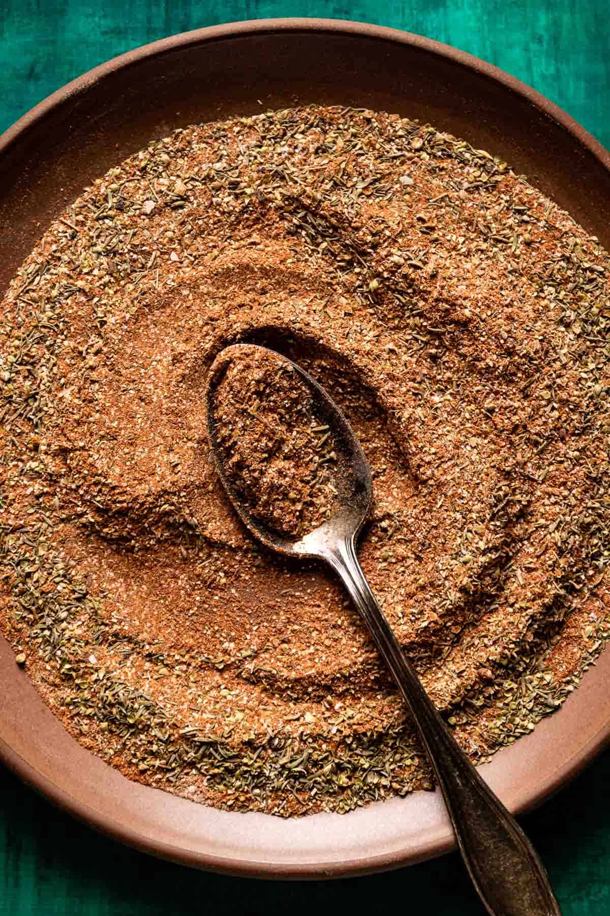 Blackened seasoning on a plate with a spoon in the middle.