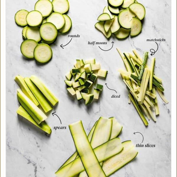 Different cut of zucchini on a marble backdrop with text on the image.