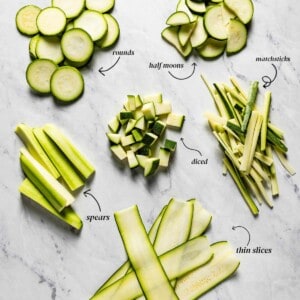 Various cuts of zucchini on a white marble with text on the image.