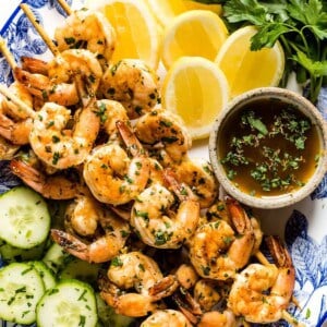 Grilled shrimp skewers for labor day bbq recipe on a plate from the top view.