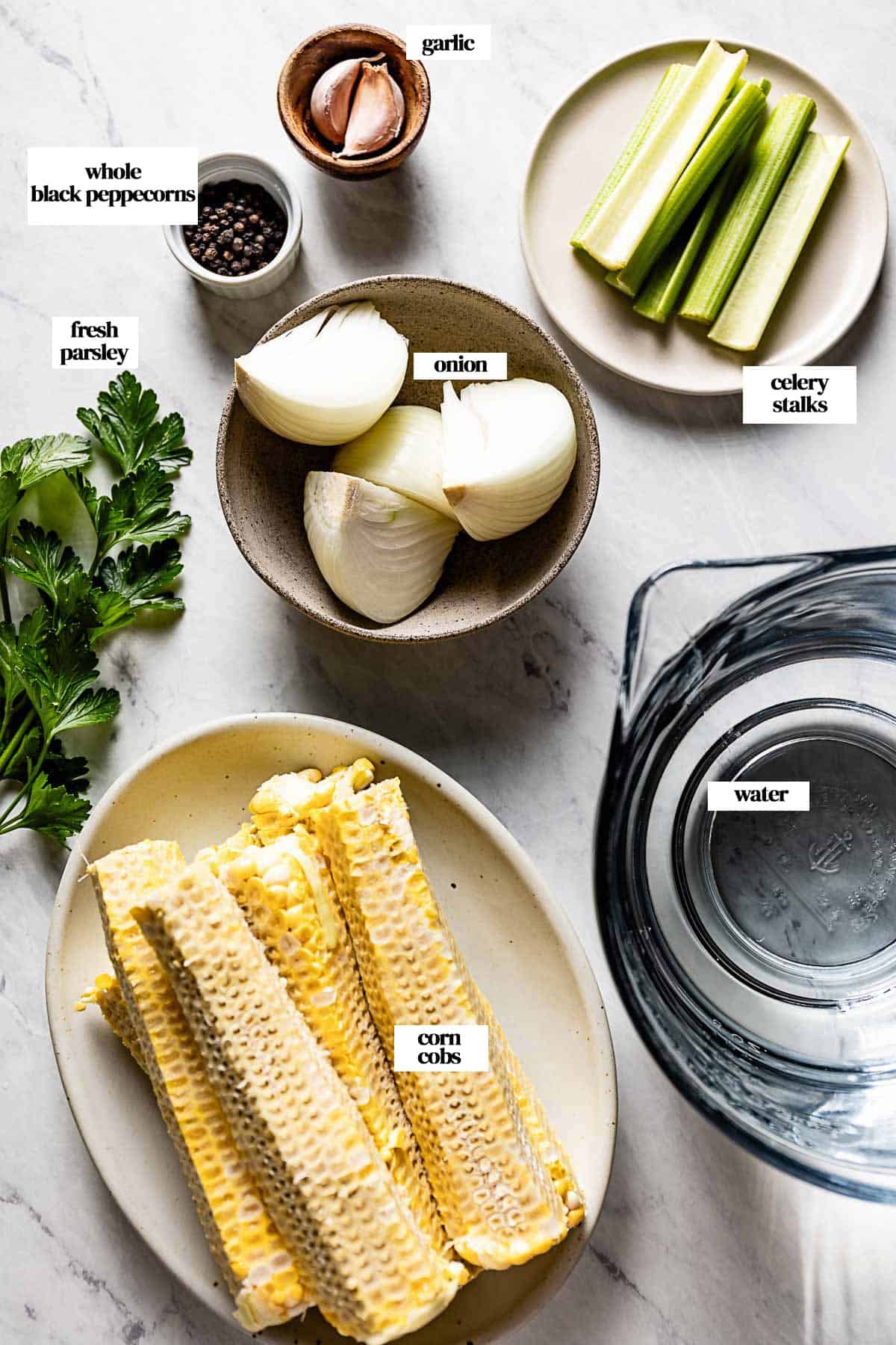 Ingredients for making corn broth from the top view with text on each ingredient.