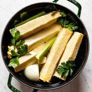 Corn cobs and vegetables in a pot from the top view.
