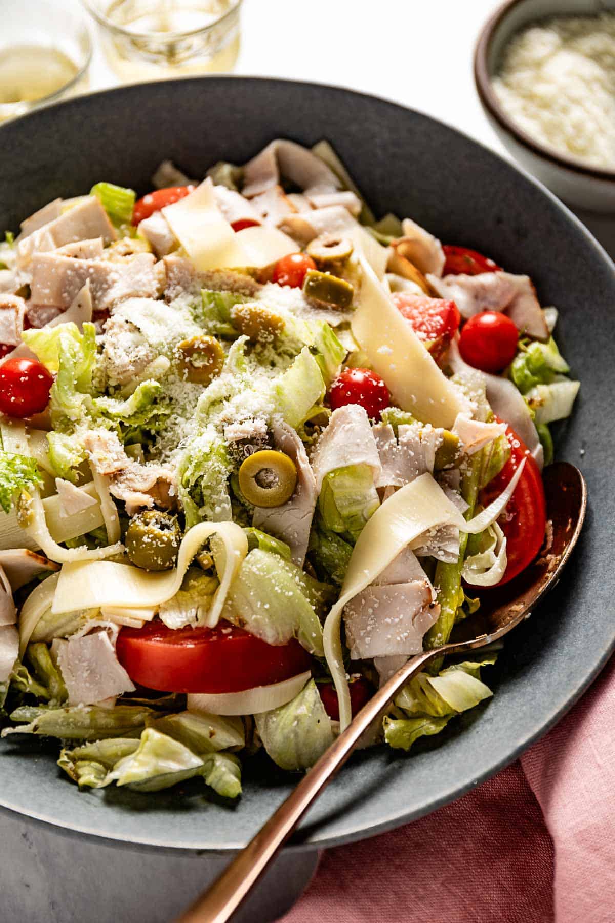 1905 Columbia salad in a bowl with a spoon on the side.