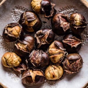 Oven roasted chestnuts in a bowl.
