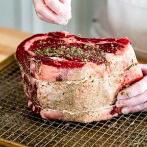 Homemade prime rib rub seasoning sprinkled over meat.