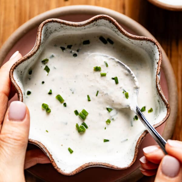 Creamy horseradish sauce in a bowl with a spoon in it.