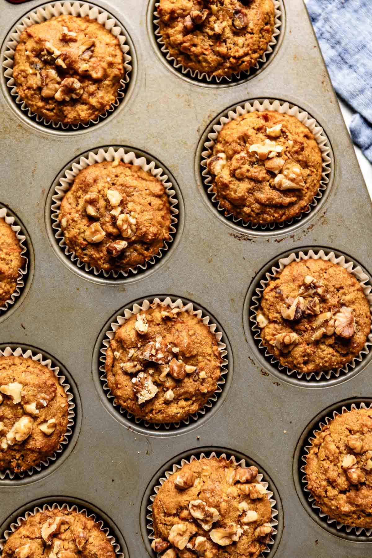 Almond flour carrot muffins fresh out of the oven in a muffin tin.