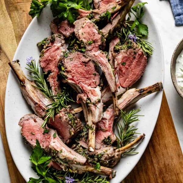 Roast rack of lamb cut into chops and placed on a serving platter.