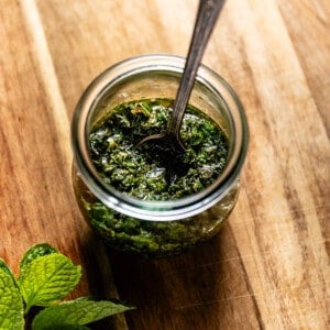 Mint sauce for lamb in a jar with a spoon.