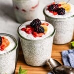 Chia seed yogurt breakfast garnished with berries in jars.