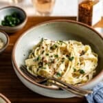 A bowl of Greek yogurt pasta with text on the image for Pinterest.
