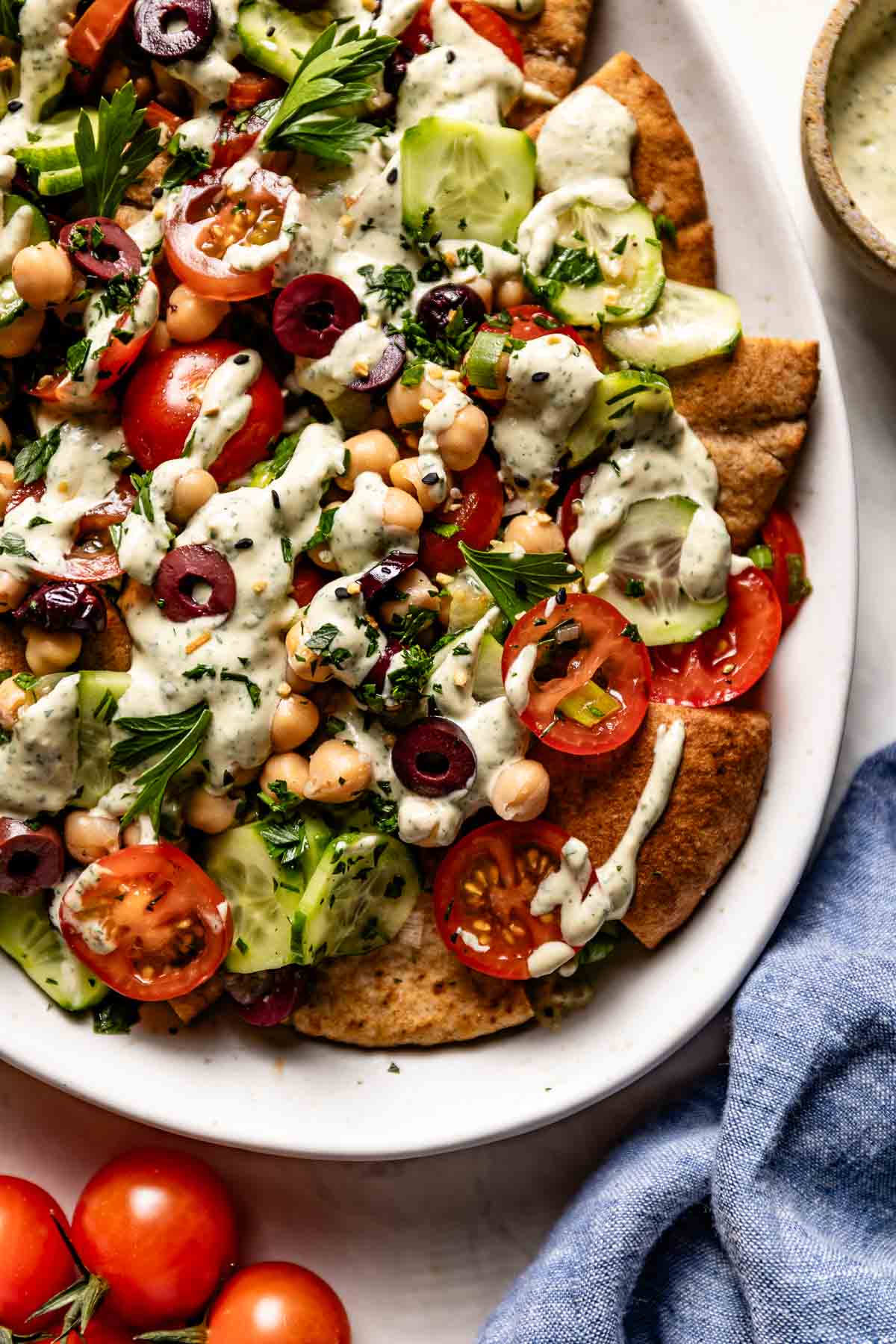 Vegan Greek nachos on a plate from the top view.